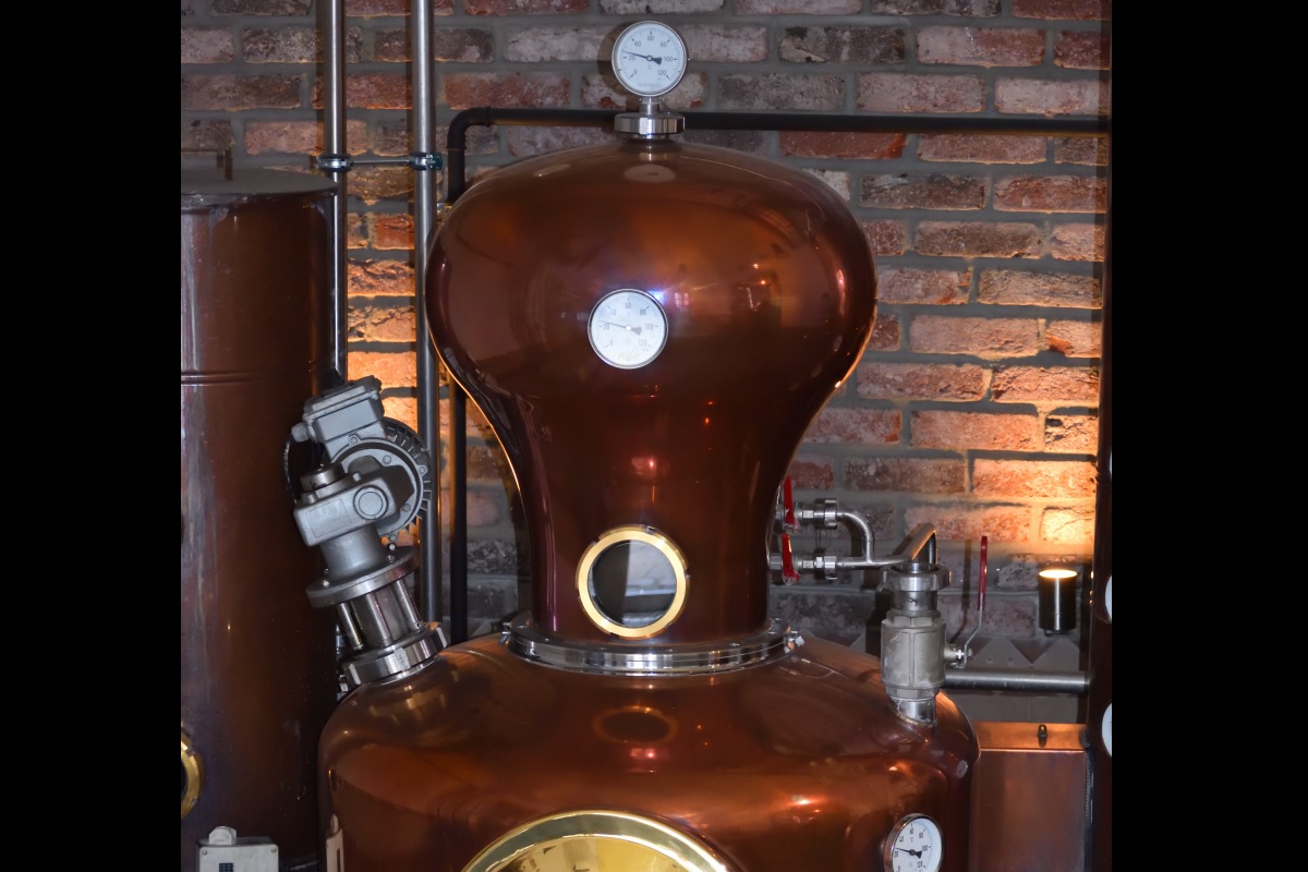Distillery in front of a brick wall